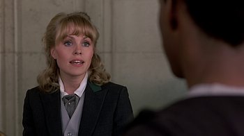 Movie still from “Beverly Hills Cop” (1984), directed by Martin Brest – A woman wearing a suit and tie talking to a man; Close Up shot, Over the shoulder angle