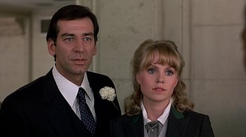 Movie still from “Beverly Hills Cop” (1984), directed by Martin Brest – A man and a woman standing next to each other; Close Up shot, Low angle