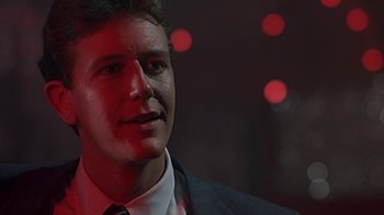 Movie still from “Beverly Hills Cop” (1984), directed by Martin Brest – A person wearing a suit and tie; Close Up shot, Low angle