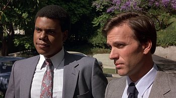 Movie still from “Beverly Hills Cop” (1984), directed by Martin Brest – Two men in suits and ties standing next to each other; Close Up shot, Low angle