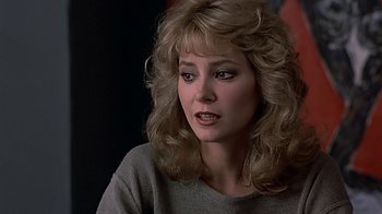 Movie still from “Beverly Hills Cop” (1984), directed by Martin Brest – A person with long hair; Close Up shot, Over the shoulder angle