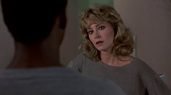 Movie still from “Beverly Hills Cop” (1984), directed by Martin Brest – A person wearing a gray shirt; Close Up shot, Over the shoulder angle