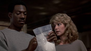 Movie still from “Beverly Hills Cop” (1984), directed by Martin Brest – A man and a woman looking at a piece of paper; Close Up shot, Low angle