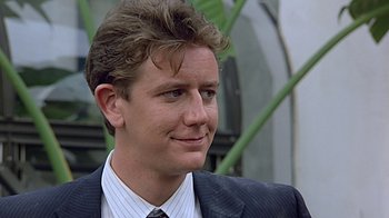 Movie still from “Beverly Hills Cop” (1984), directed by Martin Brest – A person wearing a suit and tie; Close Up shot, Low angle