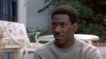 Movie still from “Beverly Hills Cop” (1984), directed by Martin Brest – A person wearing a sweater; Close Up shot, High angle