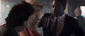 Movie still from “Beverly Hills Cop II” (1987), directed by Tony Scott – A man and a woman are standing together; Close Up shot, Over the shoulder angle