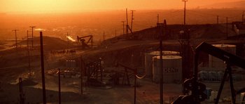 Movie still from “Beverly Hills Cop II” (1987), directed by Tony Scott – An oil field in the middle of the night; Extreme Wide shot, High angle