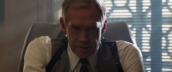 Movie still from “Beverly Hills Cop II” (1987), directed by Tony Scott – A man wearing a vest and a tie; Close Up shot, Over the shoulder angle