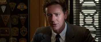 Movie still from “Beverly Hills Cop II” (1987), directed by Tony Scott – A person wearing a suit and tie; Close Up shot, Over the shoulder angle