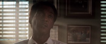 Movie still from “Beverly Hills Cop II” (1987), directed by Tony Scott – A person wearing a white shirt; Close Up shot, Low angle