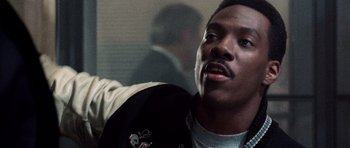 Movie still from “Beverly Hills Cop II” (1987), directed by Tony Scott – A person wearing a jacket; Close Up shot, Low angle
