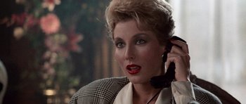 Movie still from “Beverly Hills Cop II” (1987), directed by Tony Scott – A person talking on a cell phone; Close Up shot, Over the shoulder angle