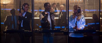 Movie still from “Beverly Hills Cop II” (1987), directed by Tony Scott – A group of people standing around a bar; Medium shot, Over the shoulder angle