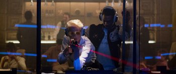 Movie still from “Beverly Hills Cop II” (1987), directed by Tony Scott – A man and a woman wearing headphones and holding a microphone; Medium shot, Low angle