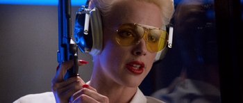 Movie still from “Beverly Hills Cop II” (1987), directed by Tony Scott – A woman wearing headphones and sunglasses while holding a microphone; Close Up shot, Low angle