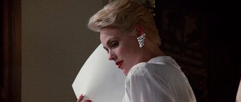 Movie still from “Beverly Hills Cop II” (1987), directed by Tony Scott – A woman with short blonde hair wearing a white shirt; Close Up shot, Low angle