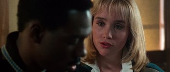Movie still from “Beverly Hills Cop II” (1987), directed by Tony Scott – A woman with blonde hair looking at a man with black hair; Close Up shot, Over the shoulder angle