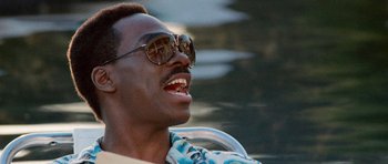 Movie still from “Beverly Hills Cop II” (1987), directed by Tony Scott – A person wearing sunglasses; Close Up shot, Low angle