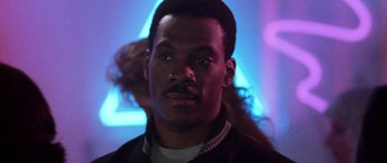 Movie still from “Beverly Hills Cop II” (1987), directed by Tony Scott – A person wearing a jacket; Close Up shot, Low angle