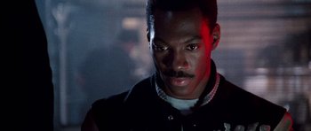 Movie still from “Beverly Hills Cop II” (1987), directed by Tony Scott – A person wearing a jacket; Close Up shot, Over the shoulder angle