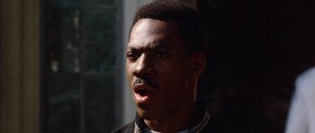 Movie still from “Beverly Hills Cop II” (1987), directed by Tony Scott – A person wearing a jacket; Close Up shot, Over the shoulder angle