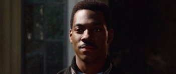 Movie still from “Beverly Hills Cop II” (1987), directed by Tony Scott – A person wearing a jacket; Close Up shot, High angle