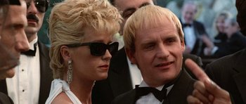 Movie still from “Beverly Hills Cop II” (1987), directed by Tony Scott – A man and a woman in formal wear standing next to each other; Close Up shot, Low angle