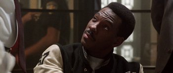 Movie still from “Beverly Hills Cop II” (1987), directed by Tony Scott – A person wearing a vest; Close Up shot, Over the shoulder angle