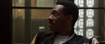 Movie still from “Beverly Hills Cop II” (1987), directed by Tony Scott – A person wearing a jacket; Close Up shot, Over the shoulder angle