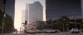 Movie still from “Beverly Hills Cop II” (1987), directed by Tony Scott – A city street filled with lots of traffic and tall skyscrapers in the background; Extreme Wide shot, High angle