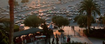 Movie still from “Beverly Hills Cop II” (1987), directed by Tony Scott – A parking lot filled with lots of parked cars; Extreme Wide shot, High angle