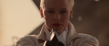 Movie still from “Beverly Hills Cop II” (1987), directed by Tony Scott – A woman holding a beer bottle in her hand; Close Up shot, Low angle