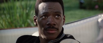 Movie still from “Beverly Hills Cop II” (1987), directed by Tony Scott – A person wearing a jacket; Close Up shot, High angle