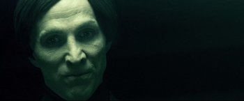 A person's face in a dark room