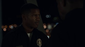 Movie still from “Beyond the Lights” (2014), directed by Gina Prince-Bythewood – A man in a police uniform is talking to someone; Close Up shot, Over the shoulder angle