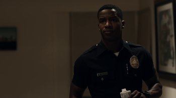 Movie still from “Beyond the Lights” (2014), directed by Gina Prince-Bythewood – A police officer is standing in a room; Close Up shot, Low angle