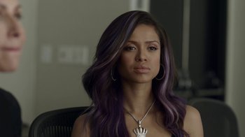 Movie still from “Beyond the Lights” (2014), directed by Gina Prince-Bythewood – A woman sitting in a chair with purple hair; Close Up shot, Over the shoulder angle