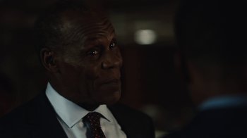 Movie still from “Beyond the Lights” (2014), directed by Gina Prince-Bythewood – An older man in a suit and tie looking to his left; Close Up shot, Over the shoulder angle