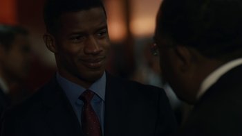 Movie still from “Beyond the Lights” (2014), directed by Gina Prince-Bythewood – A man wearing a suit and tie talking to another man; Close Up shot, Over the shoulder angle