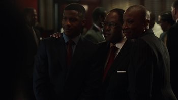 Movie still from “Beyond the Lights” (2014), directed by Gina Prince-Bythewood – A group of men in suits and ties standing next to each other; Medium shot, High angle