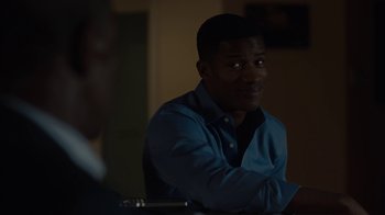 Movie still from “Beyond the Lights” (2014), directed by Gina Prince-Bythewood – A man sitting at a table in front of a window; Close Up shot, Over the shoulder angle