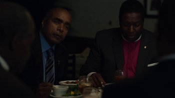 Movie still from “Beyond the Lights” (2014), directed by Gina Prince-Bythewood – A couple of men sitting at a table with food; Medium shot, Over the shoulder angle