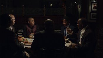Movie still from “Beyond the Lights” (2014), directed by Gina Prince-Bythewood – A group of people sitting around a table at a restaurant; Medium shot, Over the shoulder angle