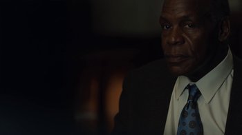 Movie still from “Beyond the Lights” (2014), directed by Gina Prince-Bythewood – A man wearing a suit and tie in a dark room; Close Up shot, Over the shoulder angle