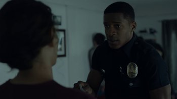 Movie still from “Beyond the Lights” (2014), directed by Gina Prince-Bythewood – A police officer talking to a person in a room; Close Up shot, Over the shoulder angle