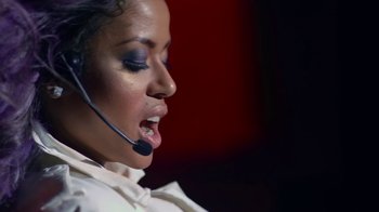 Movie still from “Beyond the Lights” (2014), directed by Gina Prince-Bythewood – A woman wearing a headset talking into a microphone; Close Up shot, Low angle