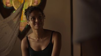 Movie still from “Beyond the Lights” (2014), directed by Gina Prince-Bythewood – A woman in a black tank top is smiling; Close Up shot, Over the shoulder angle