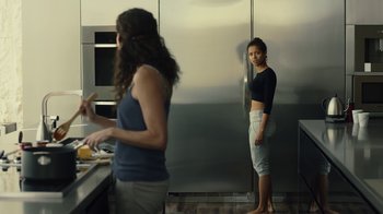 Movie still from “Beyond the Lights” (2014), directed by Gina Prince-Bythewood – Two women standing in front of an open refrigerator in a kitchen; Medium shot, Over the shoulder angle