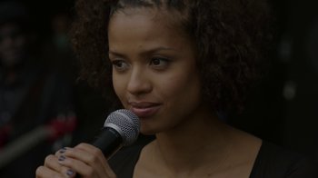 Movie still from “Beyond the Lights” (2014), directed by Gina Prince-Bythewood – A woman holding a microphone up to her face; Close Up shot, Over the shoulder angle