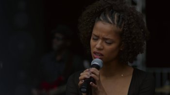 Movie still from “Beyond the Lights” (2014), directed by Gina Prince-Bythewood – A woman holding a microphone up to her mouth; Close Up shot, Low angle
